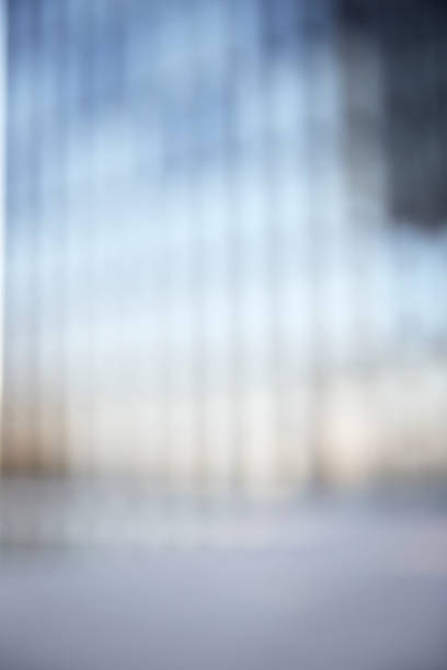 Defocused high res photograph of a modern facade, shot with a 70mm lens and full-frame DSLR. Background for fashion or business photography.