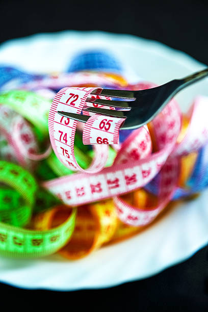 istock Tape measure around a fork, like a strand of pasta 512688376