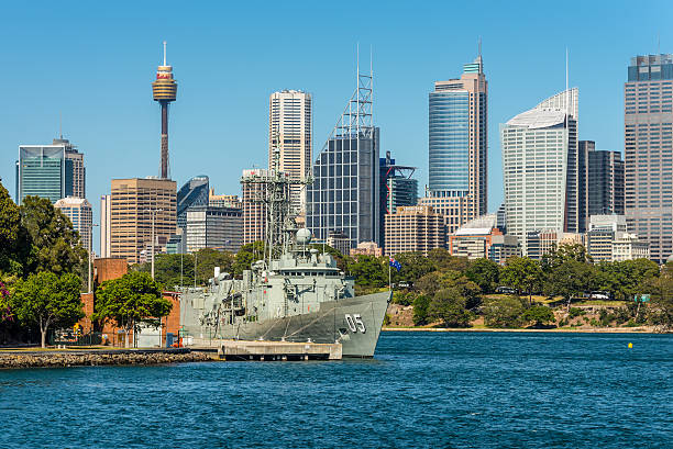 View of Sydney City CBD Skyline - Australia Sydney, Australia - November 9, 2014: Australian Sydney landmark - city CBD high rises and towers forming megapolis cityscape summer day and the Royal Australian Navy's Frigate Melbourne (III) in the foreground, Sydney, Australia. australian navy stock pictures, royalty-free photos & images