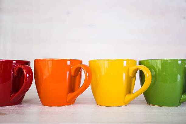 istock stack of colorful coffee cups on a white wooden background 512690358
