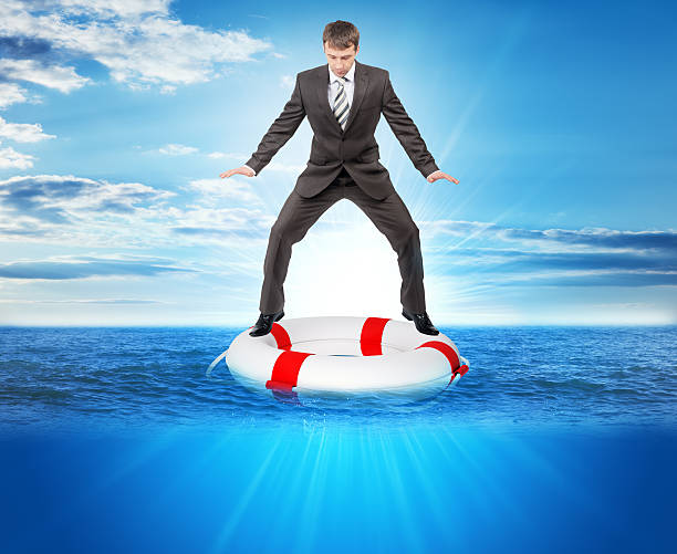 istock Buisnessman on lifebuoy 512691136