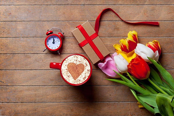 istock bunch of tulips, red clock, gift and a cup 512691168