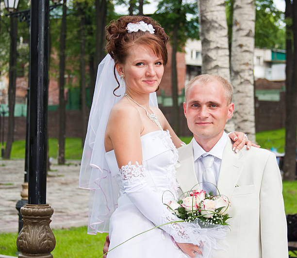 istock happy groom and fiancee in a park 512692892
