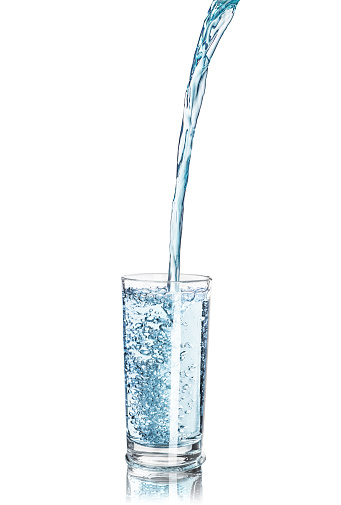 a strong pouring water pouring into a glass isolated on white background