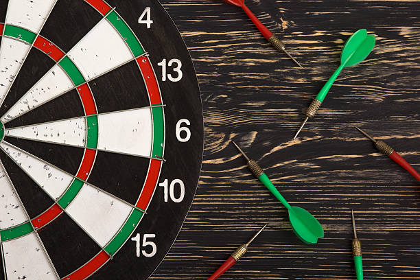 istock The darts isolated on wooden background 512693508