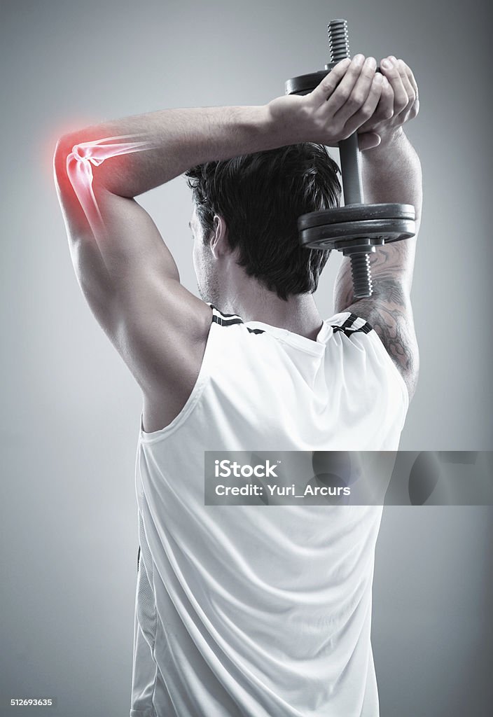 Overwork can cause injury Rearview studio shot of a man's elbow joint highlighted as he works out Elbow Stock Photo