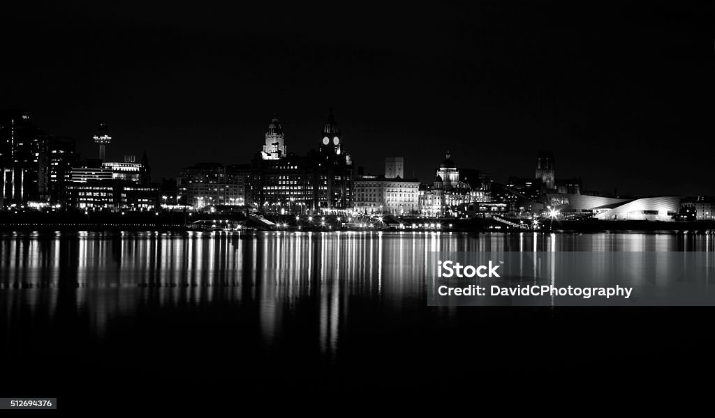 Liverpool Cityscape A time exposure monochrome version of Liverpools iconic World Heritage waterfront on a still flat calm evening on the River Mersey Night Stock Photo