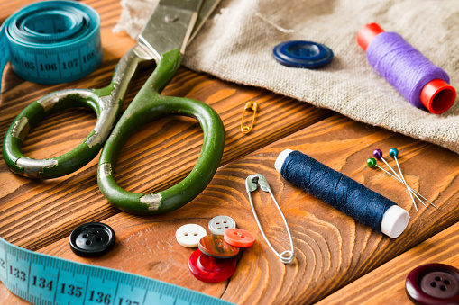 Sewing Accessories on wooden background closeup