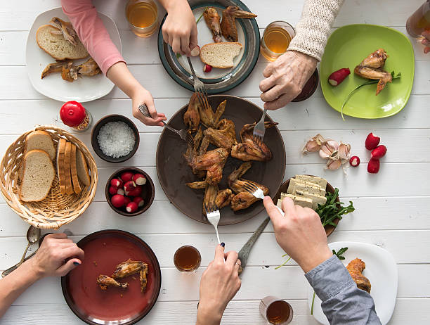 istock family having roasted chicken wings for dinner 512695028