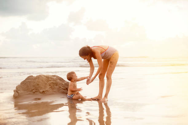 istock Pregnant mother and her son at the beach 512695034