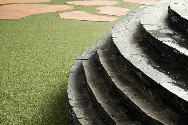 istock Stone and curve staircase on artificial turf and brown stone 512695238