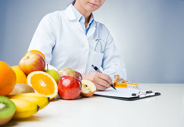istock Professional nutritionist writing medical records 512695634
