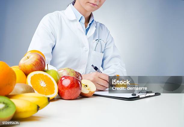 Professional Nutritionist Writing Medical Records Stock Photo - Download Image Now - Nutritionist, Healthy Eating, Doctor