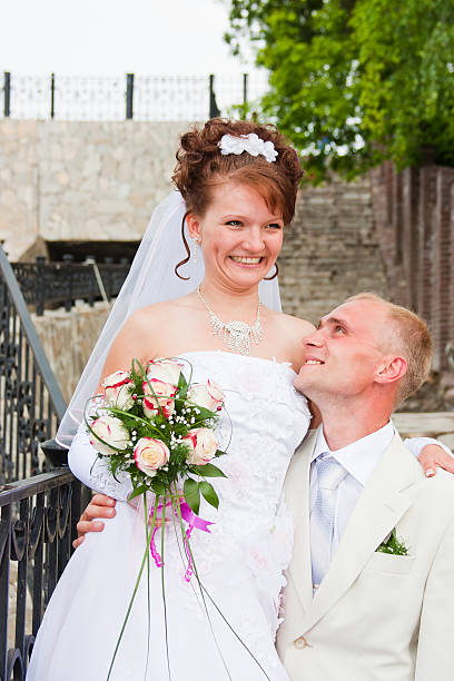 istock groom and fiancee in a park 512695966