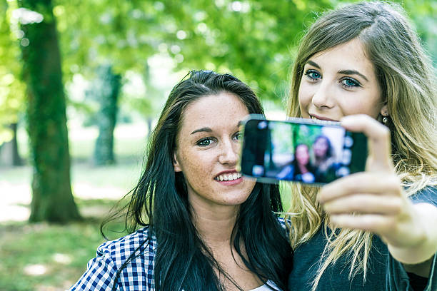 istock Two young women having fun with smartphone 512696135