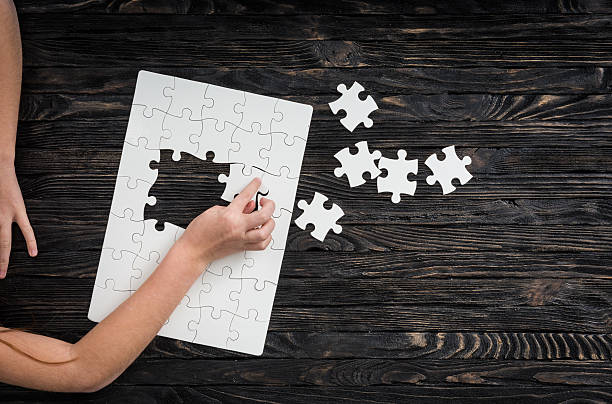 istock hands starting to collect puzzle pieces 512697578