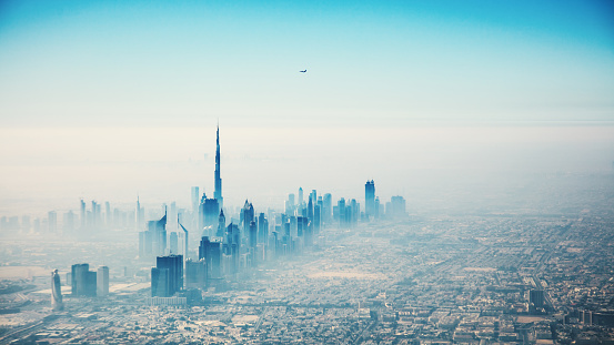 Dubai city in sunrise aerial view with foggy haze