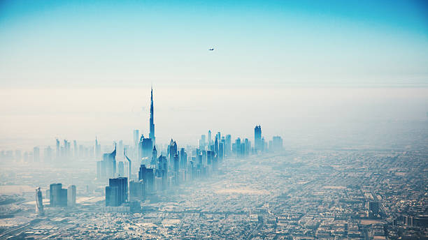 Dubai city in sunrise aerial view Dubai city in sunrise aerial view with foggy haze dubai skyline stock pictures, royalty-free photos & images