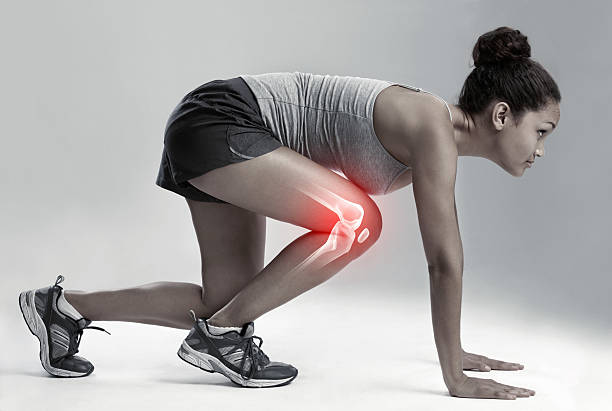 Keep your eye on the prize! - Fitness Goals Full length studio shot of a female runner with cgi joint inflammation runner on start pose stock pictures, royalty-free photos & images