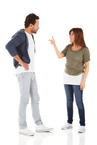 Full length portrait of mature interracial couple having an argument over white background