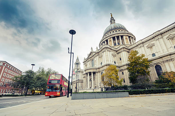 istock Red double decker bus at Saint Paul's Cathedral, London, vintage 512699295