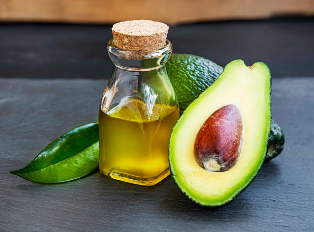 istock Avocado oil in bottle with avocado fruit 512700144
