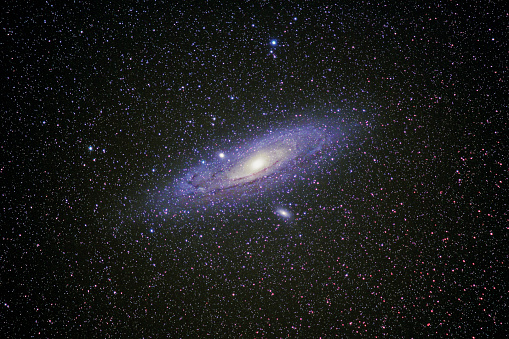 A deep night sky view of the Andromeda Galaxy M31 as seen from the sky of Dark Sky Alqueva region, located in Portugal, is the first starlight tourism destination in the world with an impressive sky quality. Andromeda is a spiral galaxy approximately 2.5 million light-years from Earth in the Andromeda constellation, captured in this wide view with a Canon 200mm lens f/2.8 with a portable Vixen Polarie Mount.