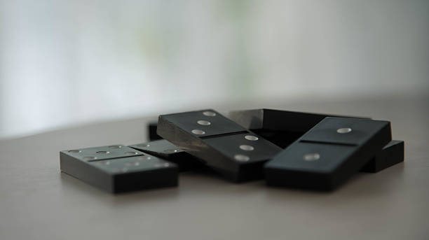 istock dominoes on a wooden table isolated  light background 512701420