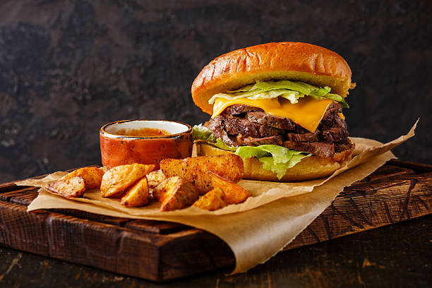 Pastrami Burger with sliced Roast beef and potato wedges