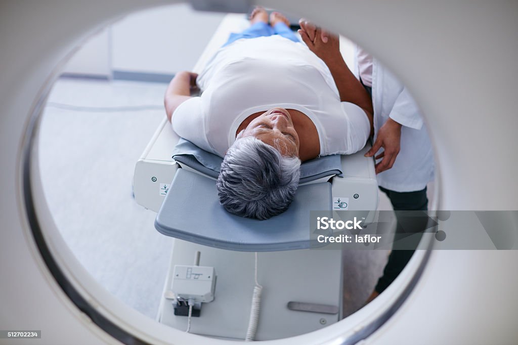 Preparing for the scan Shot of a senior woman being comforted by a doctor before and MRI scanhttp://195.154.178.81/DATA/i_collage/pu/shoots/806398.jpg Cancer - Illness Stock Photo