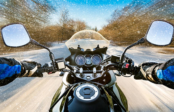 Biker First-person view. Winter slippery road stock photo