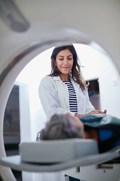 This won't hurt a bit! Shot of a mature woman being comforted by a doctor before and MRI scanhttp://195.154.178.81/DATA/i_collage/pu/shoots/806398.jpg medical x ray stock pictures, royalty-free photos & images