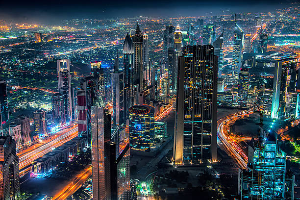 Dubai city by night Dubai cityscape with the famous Sheikh Zayed Road khalifa stock pictures, royalty-free photos & images