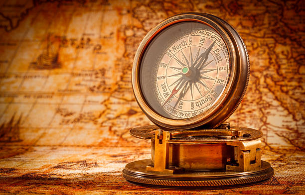 istock Vintage compass lies on an ancient world map. 512703126