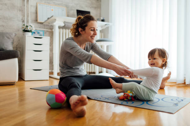 istock Mother Exercise With Her Baby At Home 512703282