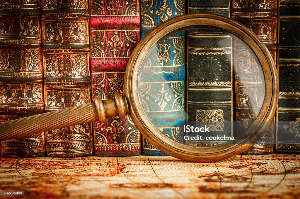 Old books Ancient old books and magnifying glass Backgrounds Stock Photo