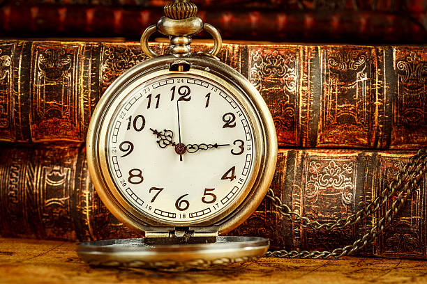 istock Old Books and Vintage pocket watch 512704868