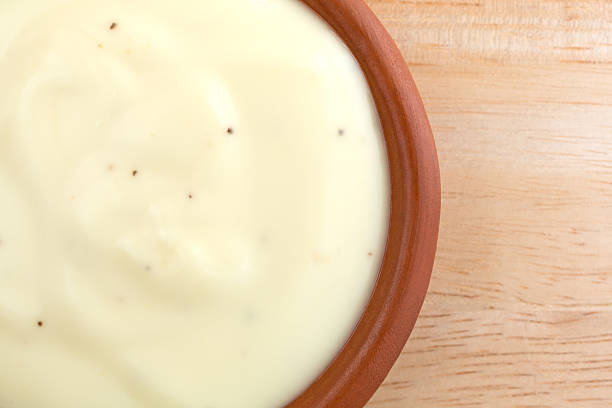 istock Bowl of blue cheese salad dressing on wood table top 512704924
