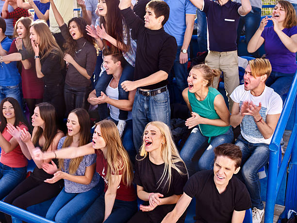 istock Sport fans clapping and singing on tribunes 512725490