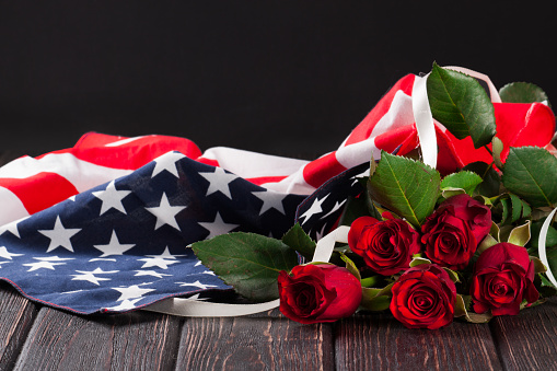 Rose and american flag on wood background