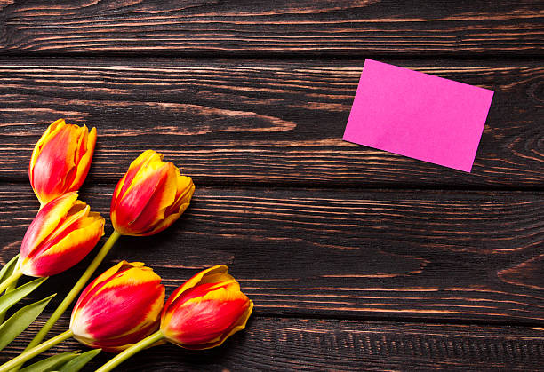 istock Tulips and a card on a wood 512727926