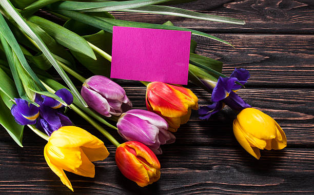 istock Tulips and a card on a wood 512728202