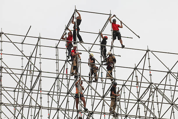  Saint-Petersburg, Russia - June 26, 2015: The installers are building a huge metal structure to be installed on it big  stage monitors for live entertainment in the town square.