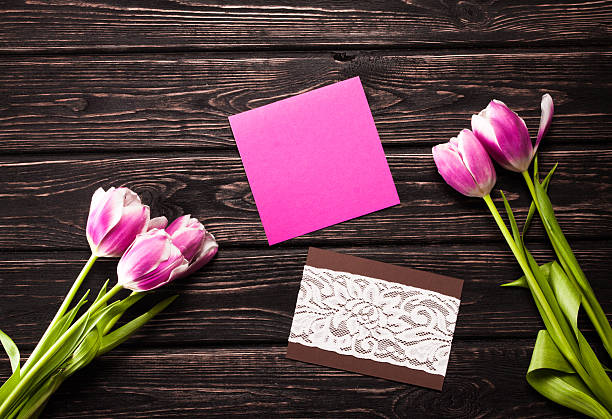 istock Tulips and a card on a wood 512729760