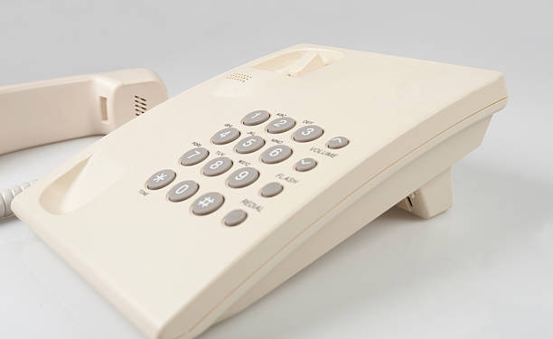 istock beige landline phone on gray background 512729962
