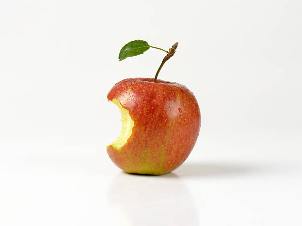 Red apple with a bite taken Red apple with a bite taken on white background apple with bite out stock pictures, royalty-free photos & images