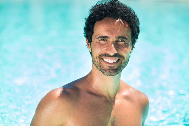 istock Smiling young man relaxing in the water 512731898