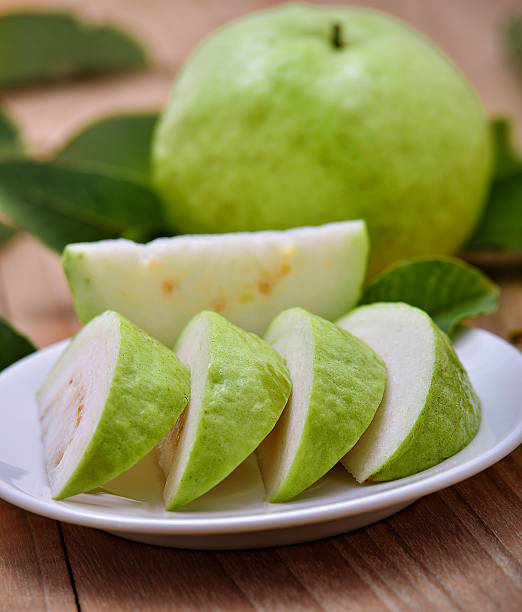 istock Fresh guava fruit on wooden background 512731950