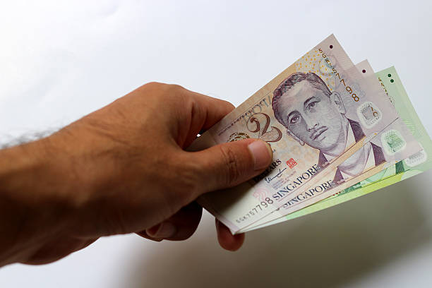 istock The Hand get Money Singapore dollar on white Background 512733296