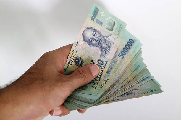 istock The Hand get Money Vietnam dong on white Background 512733438